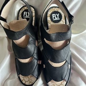 Fly London black leather sandals.